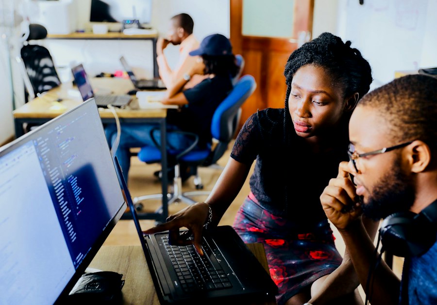 Woman and man work at a monitor