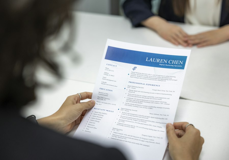 Woman reads a resume at a table