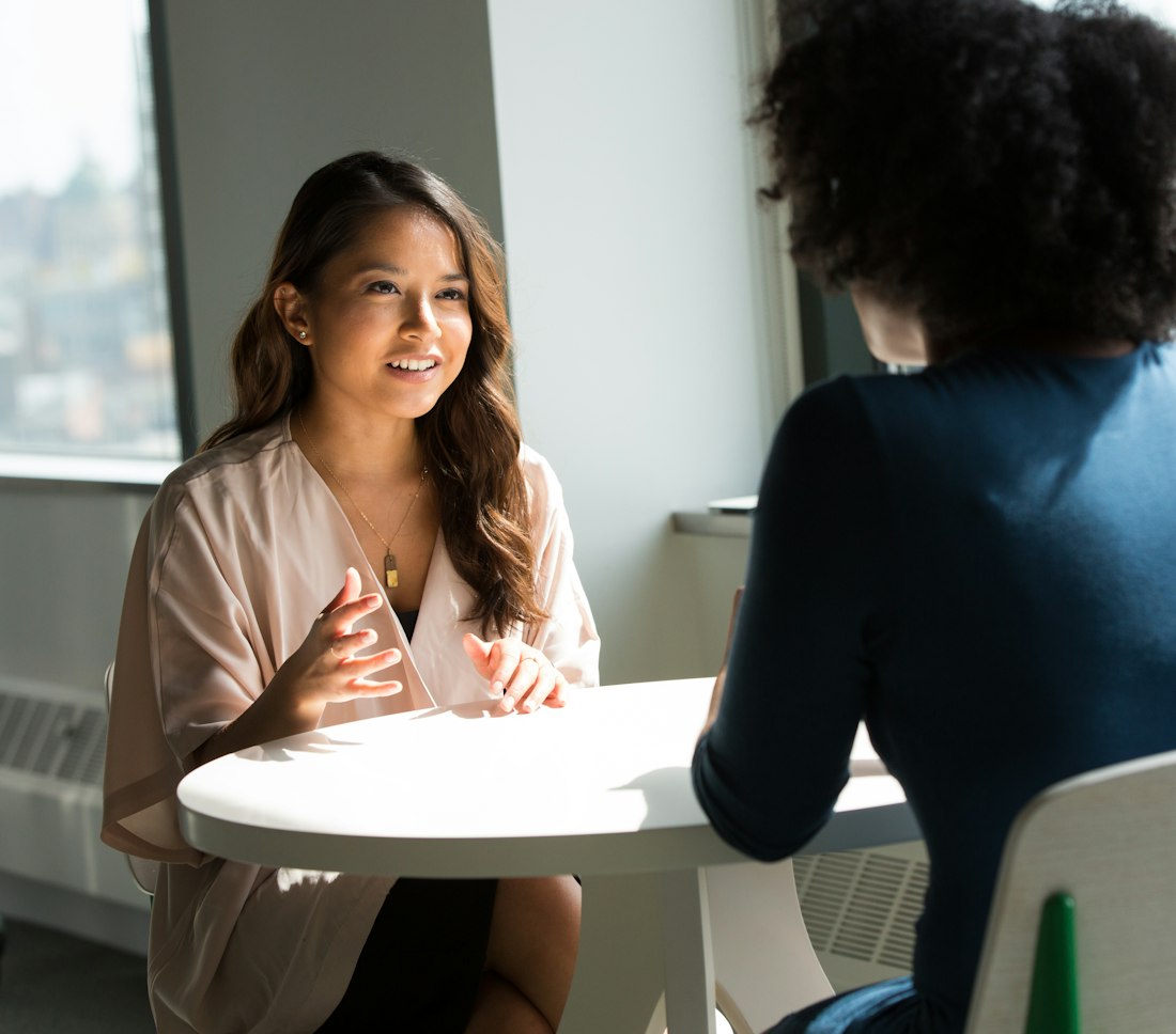 Two women in conversation, seated