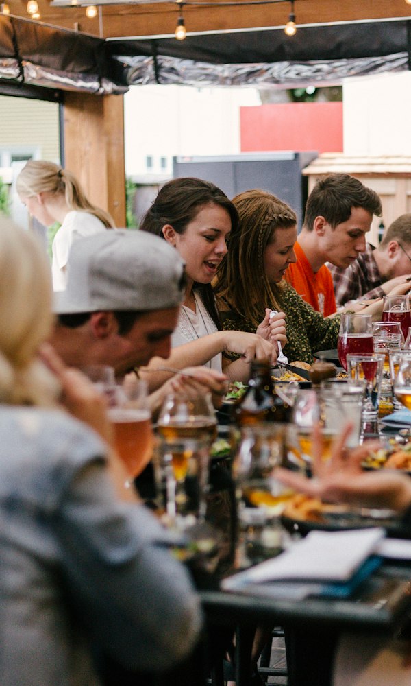 People at a table talking and eating