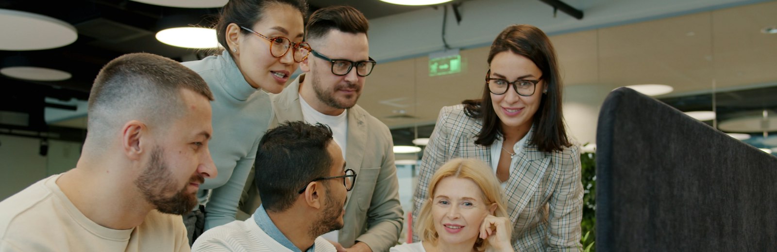 Diverse team around a laptop