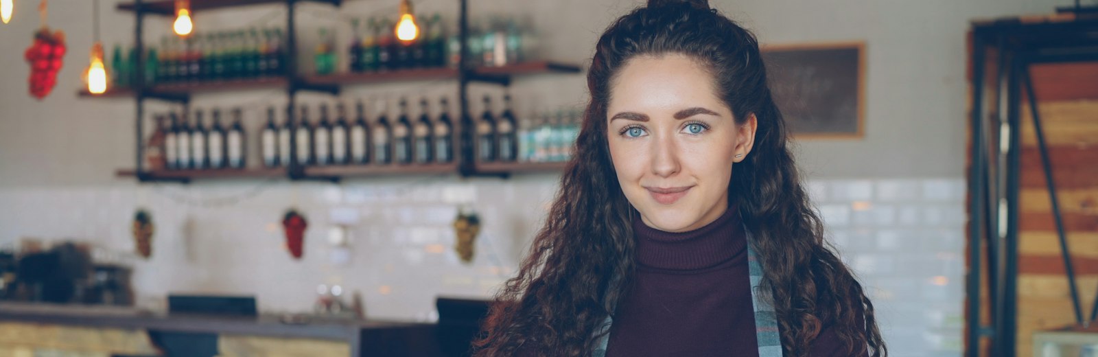 Woman smiles in her coffee shop